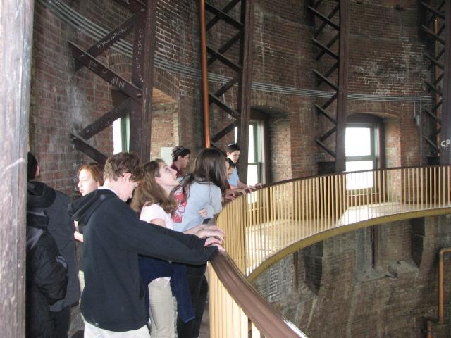 Photo by Ms. R. Gina Renee. Seventh grade students try not to fall while peering over a balcony at the Kansas State Capitol.