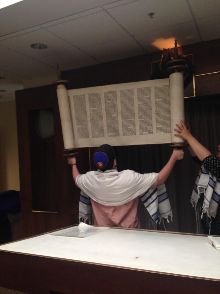 Photo+by+Adena+Goldberg.+Sophomore+Sam+Matsil+shows+off+his+strength+as+he+lifts+the+Torah.