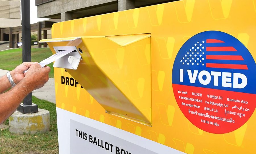 A voter drops his ballot for the 2020 US elections into an official ballot drop box at the Los Angeles County Registrar in Norwalk, California on October 19, 2020. - Voter turnout is ten times higher than in 2016 in California according the Secretary of State Alex Padilla as over 600,000 Los Angeles County ballots are already at the county registrar. (Photo by Frederic J. BROWN / AFP) (Photo by FREDERIC J. BROWN/AFP via Getty Images)