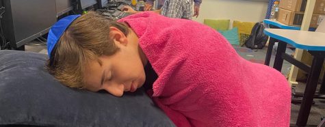 Senior Ethan Sosland falls asleep in his yearbook classroom. Image by Zach Hardy
