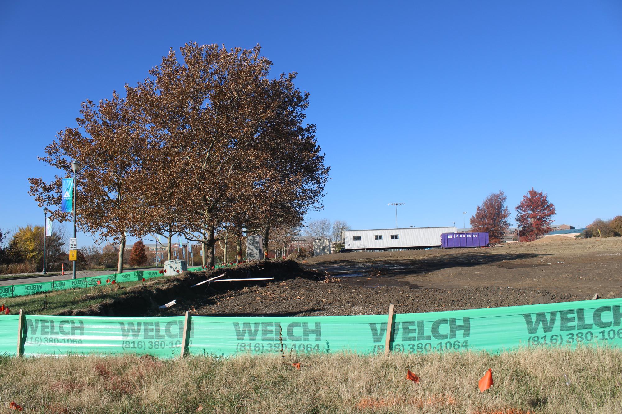 The barrier of the construction site, with the shed in the background. Image by Skyler Penner.