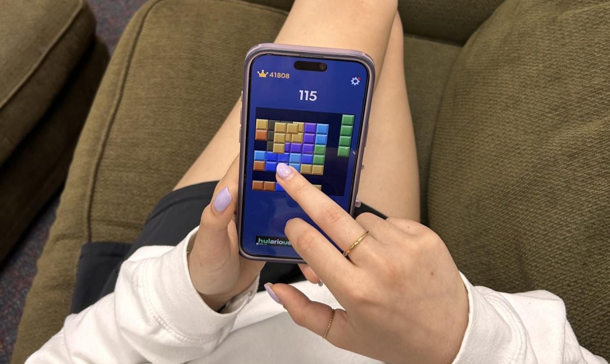 Sometimes, teens just need a break from learning. Here we can see Junior Avital Mullokandova destressing from her busy day at school with a nice round of block blast. Photo by Elia Ellis