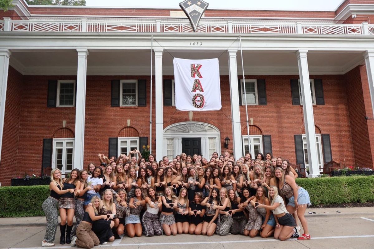 “Bid Day” at Kappa Alpha Theta at the University of Kansas. Girls outside the sorority house pose for a picture after becoming members of the sorority. Photo provided by Sophie Stang

