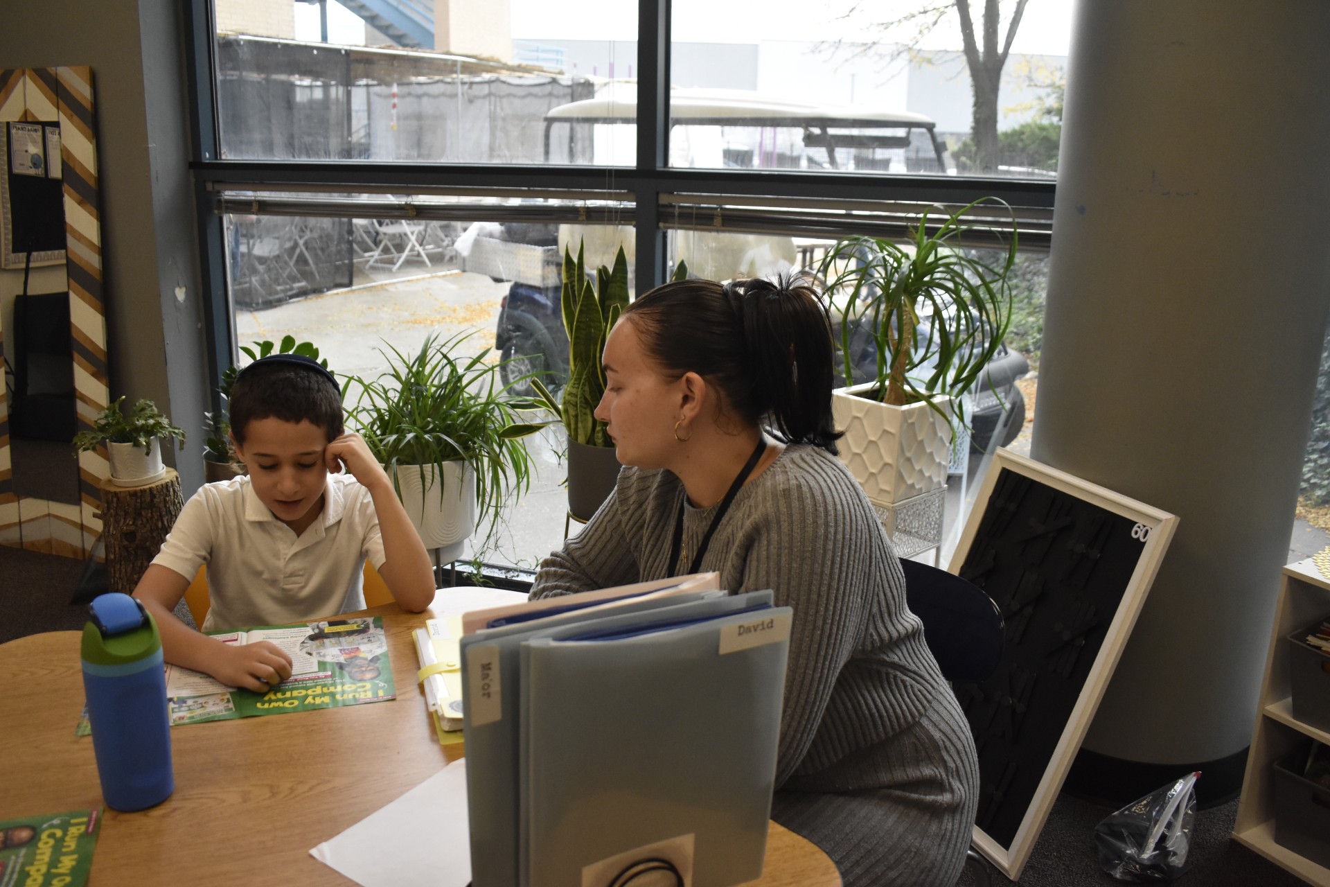 Ms. Kania is seen helping a student with his work, showing how helpful and supportive she is. Photo by Jaxson Rosenberg.